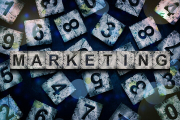 Marketing, words, above different numbers, on a dark blue background, with different letters. Alphabet on stone blocks. Business.