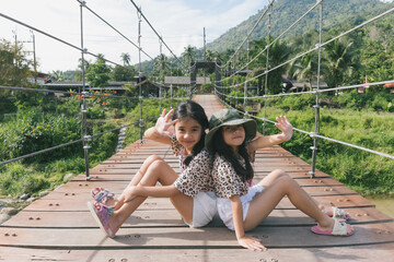my daughter wooden bridge across the river in Khiriwong village