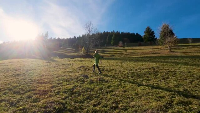 Slow motion of a young woman walking and enjoying time in nature in Autumn