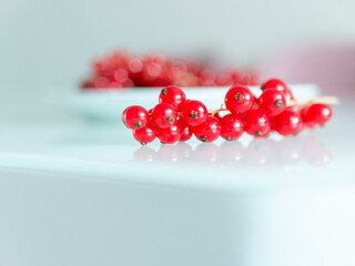 A bunch of red currants on a white background