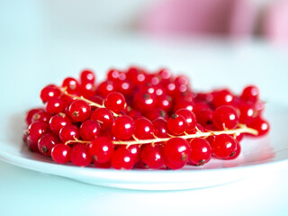 A bunch of red currants on a white background
