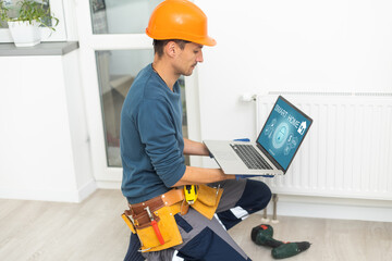 plumber at work. Installing water heating radiator