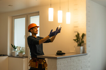 Portrait of an electrician holding an energy-saving lightbulb