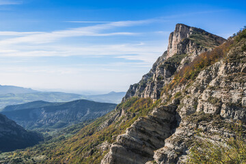 Autumn landscape in Les Trois Becs in Drôme provençale. The top limestone rocks is covered with green grass