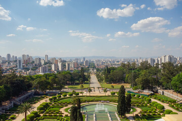 high angle view of Ipiranga Museum garden and fountains with Sao Paulo cityscape as backdrop, Brazil