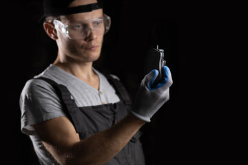 male auto mechanic holding brake pads in hand
