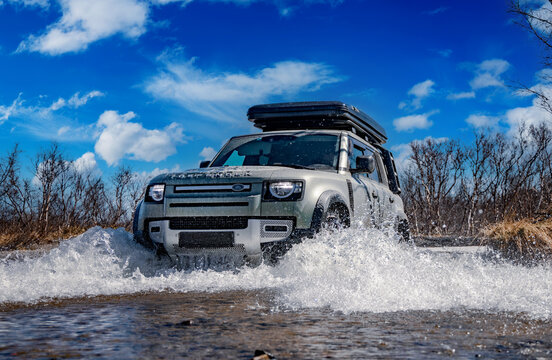 Rybachy, RUSSIA - May 30 2022: Off-roading New Land Rover Defender. The Land Rover Defender is a series of British off-road cars and pick-up trucks.