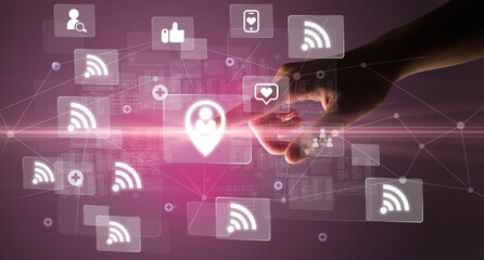 Hand pressing social media multimedia application screen with media icons on futuristic concept