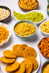 Indian Tea time snacks in group. Sev, chivda, farsan, mixture, bakarwadi served in different bowls