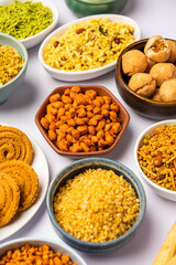Indian Tea time snacks in group. Sev, chivda, farsan, mixture, bakarwadi served in different bowls