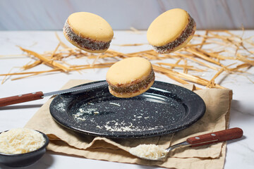 Argentine Alfajores flying on a plate. Traditional argentinian gastronomy.