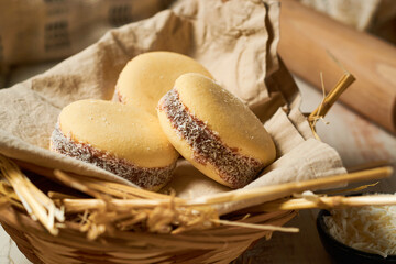 Traditional Argentinian alfajores with dulce de leche on marble table. Argentine gastronomy concept.