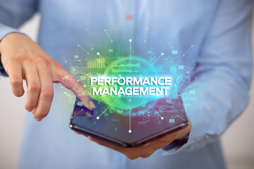 Businessman holding a foldable smartphone, new business concept