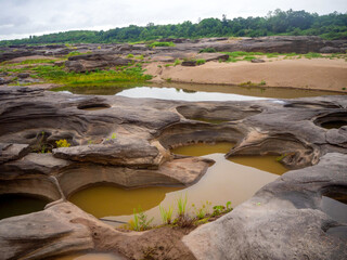 A lot of hole brownstone with the Mekong river in the dry season at Sam Phan Bok, Ubon Ratchathani.