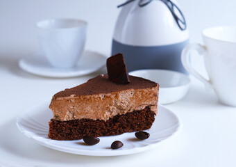 Part of a chocolate dessert cake on a plate in bright light. Shallow depth of field