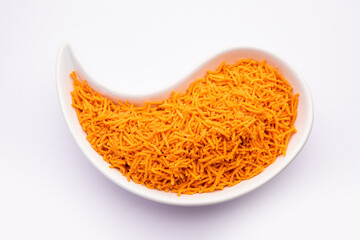 Tomato sev is a crispy crunchy orange colored flavored fried farsan with salt and spice powders
