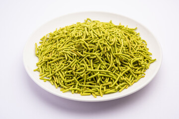 palak sev is a crispy crunchy green colored spinach flavored fried farsan with salt, spice powder