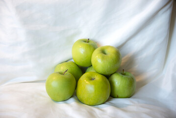 Green apples on a white background
