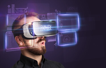 Businessman looking through Virtual Reality glasses, tech concept