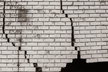 Building Exterior Wall Cracked Damaged Closeup abstract background sepia black and white photograph.