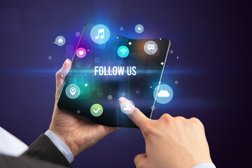 Businessman holding a foldable smartphone