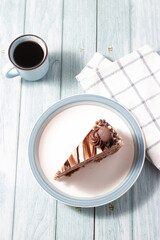 Delicious chocolate cake with fluffy cocoa sponge and marble effect icing with a cup of coffee.