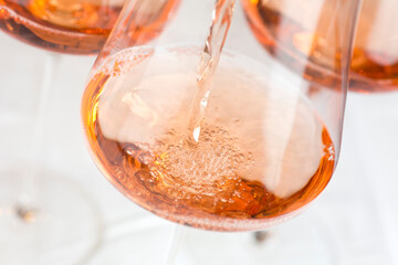 Pouring rose wine in a glass