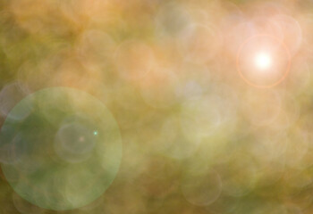 Bokeh background in earth tones, bright light lens flare