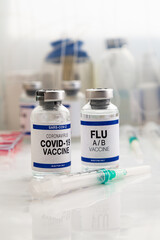 Coronavirus vaccine bottles and Flu Shot vaccine for booster vaccination for new variants of...