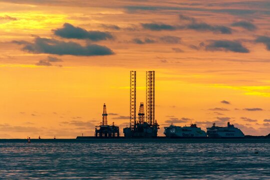 Silhouette of a harbor in Weihai with ships and loading equipment at sunset
