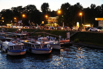 Saint Petersburg, Russia - August 19, 2022: Pleasure tourist ships at the city pier on the Admiralteyskaya embankment