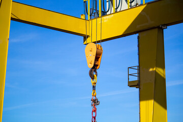 gantry crane with hook against blue sky 