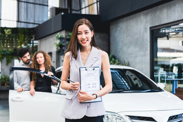 Employees deliver vehicles to customers couple is picking up a car from the garage.