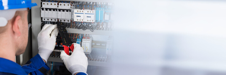 Male Electrician Repairing Fusebox