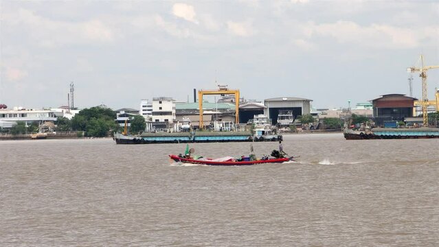 River traffic in the Chao Phraya estuary, Samut Prakan, Thailand