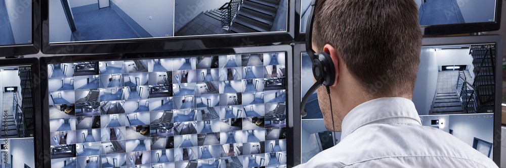 Aufkleber Operator Looking At Multiple Camera Footage On Computer
