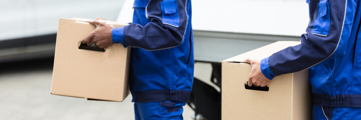 Two Men Holding The Cardboard Boxes