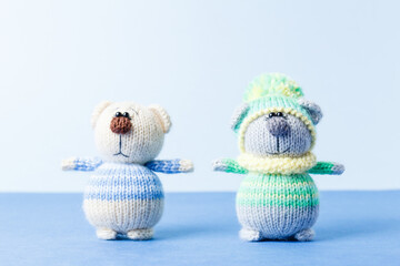 Knitted toys doing exercises. A plush bears knitted from threads in decorative clothes. Children's...