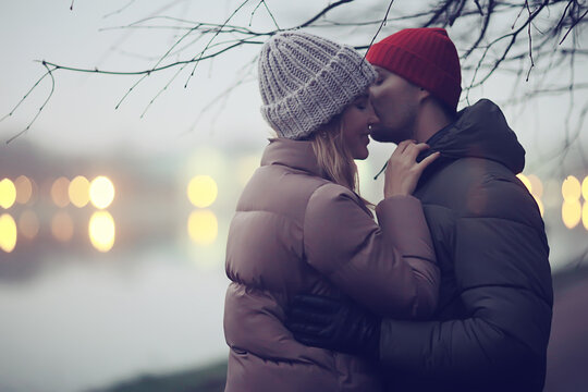 couple in love winter evening hugging outside, seasonal abstract background, weather twilight rain