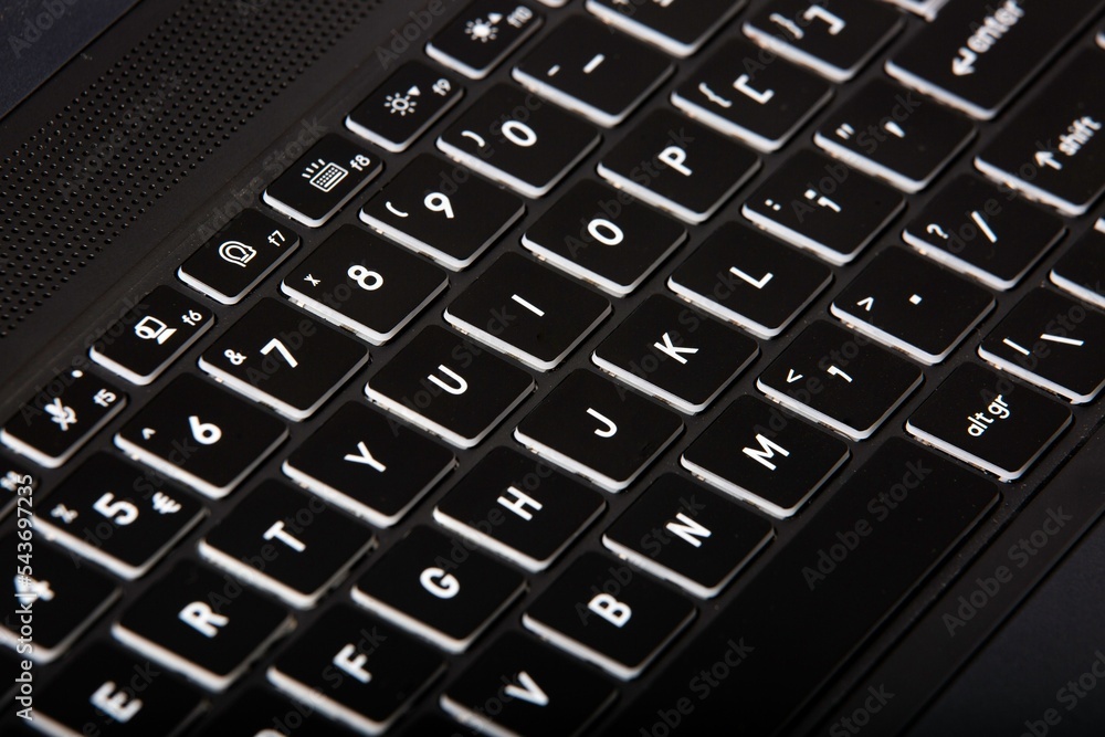 Poster closeup of a black computer keyboard with white letters and numbers on it
