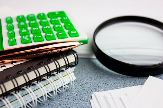 Accounting Items Business Concept.Calculator Notebooks And Magnifier.