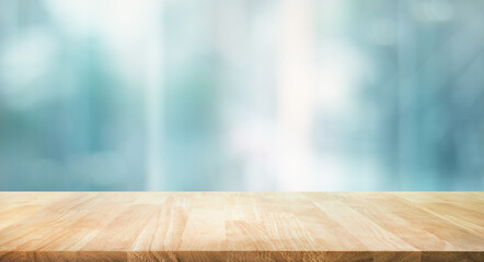 Selective focus.Top of wood  table with window glass and cityscape background. © hakinmhan