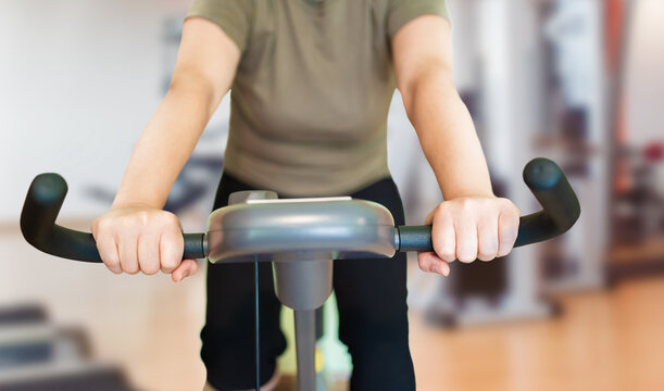 Shot Of A Young Woman Using An Exercise Bike In The Gym