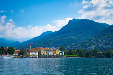 Stunning landscape of picturesque Lake Lugano and the green lush Swiss Alps in the distance. Idyllic town Lugano, Switzerland,  on a sunny summer day.