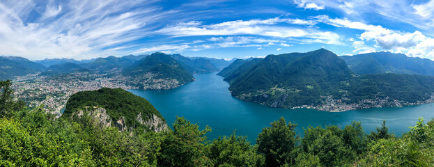 Obraz premium Spectacular panoramic view over the city of Lugano, the Lugano Lake and Swiss Alps, visible from Monte San Salvatore observation terrace, canton of Ticino, Switzerland.