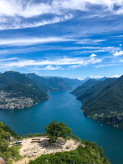 Scenic view over the city of Lugano, the Lugano Lake and mountain peaks of Swiss Alps, visible from Monte San Salvatore observation terrace, canton of Ticino, Switzerland.