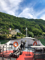 Stunning landscape of picturesque Lake Lugano and the green lush Swiss Alps in the distance, visible from the boat, Lugano, Switzerland.