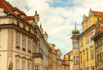 Naklejka premium Buildings in historic old town section of Prague, Czech Republic. Red roofs and architecture with medieval embellishments are seen everywhere.