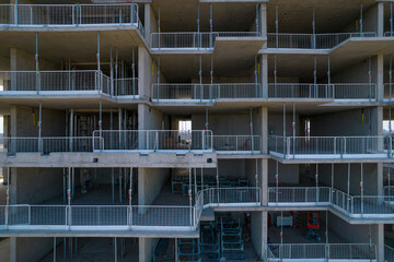 Empty construction site, incomplete high rise building with beams made of concrete and steel reinforcement. Apartment residential skyscraper. Real Estate and housing shortage crises.