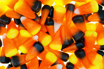 Candy Corn background close up image, orange, brown, white, back lighted, glowing.